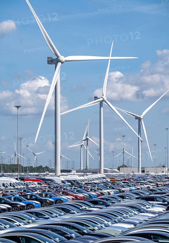 Storage area for new cars in the port of Vlissingen-Oost, vehicles are temporarily stored on over 100 hectares to ship them from Europe to the United Kingdom, Ford cars, others such as models from the Chinese car manufacturer BYD are delivered from here in Europe, wind farm, Netherlands