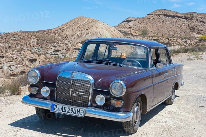 Brown Mercedes-Benz W110 classic car in the desert with sand and blue sky in the background, shiny chrome, classic car, Tabernas desert, Desierto de Tabernas, Tabernas, Almeria, Andalusia, Spain, Europe