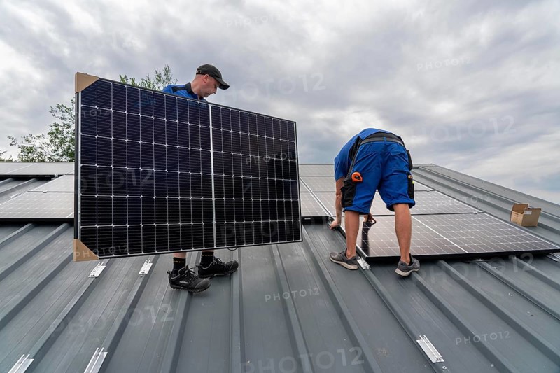 Installation of solar modules on the roof of a barn on a farm, over 240 photovoltaic modules are installed on the roof, North Rhine-Westphalia, Germany, Europe