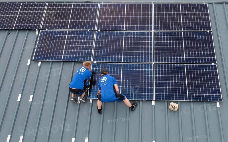 Installation of solar modules on the roof of a barn on a farm, over 240 photovoltaic modules are installed on the roof, North Rhine-Westphalia, Germany, Europe