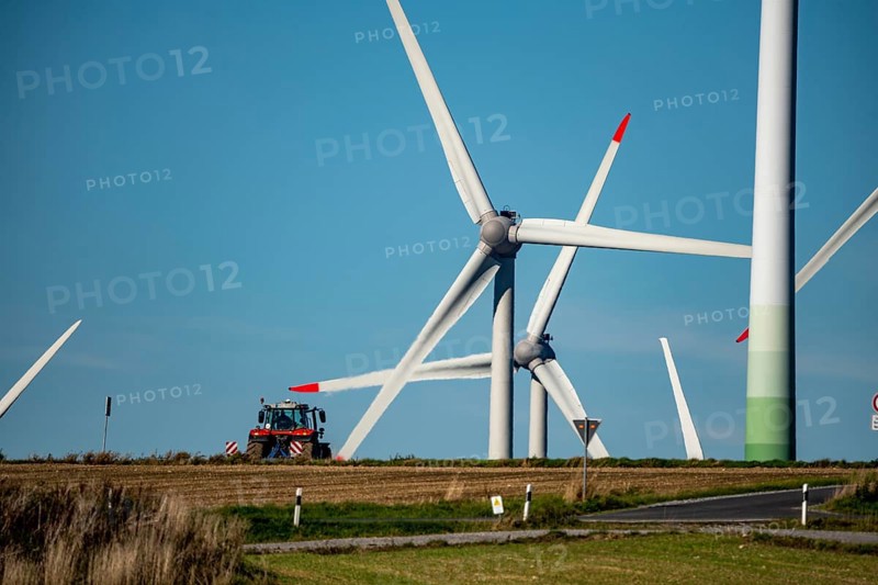 Wind farm near Lichtenau, wind turbines, country road, Driburger Straße, tractor at work in the field, North Rhine-Westphalia, Germany, Europe