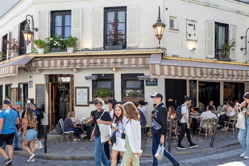 People enjoying coffee and company in a café in Montmartre, Paris