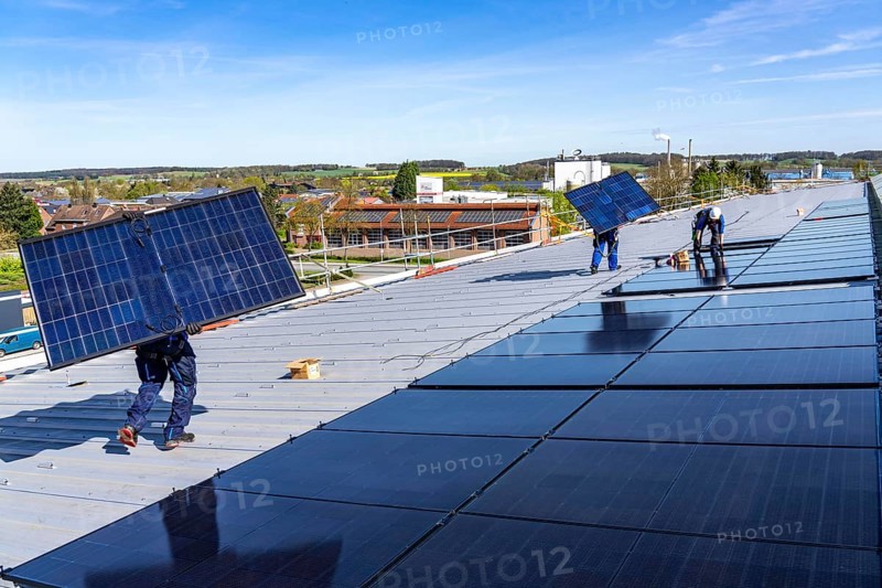 Installation of solar modules on the roof of a commercial enterprise, over 400 photovoltaic modules are installed on the roof, North Rhine-Westphalia, Germany, Europe