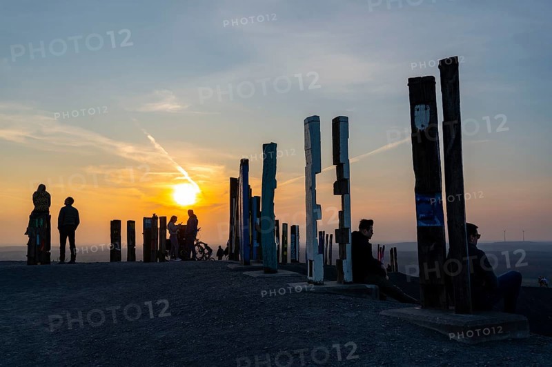 The Haniel spoil tip, 185 metre high spoil tip, at the Prosper Haniel mine, which was closed in 2019, artwork Totems by the sculptor Augustin Ibarrola, sunset, Bottrop, Germany, Europe