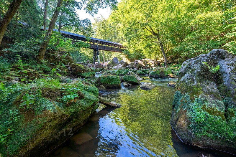The Irrel Waterfalls, rapids in the lower reaches of the Prüm, covered wooden bridge for hikers, between Prümzurlay and Irrel, in the Eifel district of Bitburg-Prüm, Rhineland-Palatinate. Germany