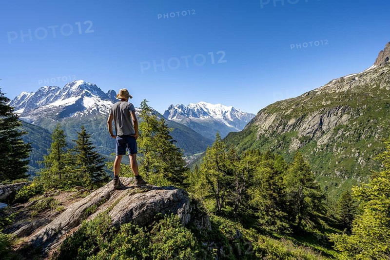 Mountaineer in front of a mountain panorama with glaciated mountain peaks, Aiguille Verte with Aiguille du Midi and Mont Blanc, hike to Aiguillette des Posettes, Chamonix, Haute-Savoie, France, Europe