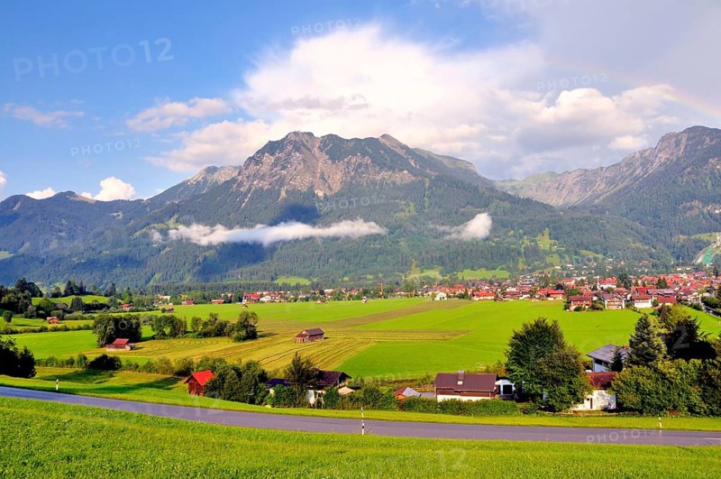 View over Oberstdorf with rainbow on Rubihorn and Geißalphorn, Schattenberg on the right, Oberallgäu, Bavaria, Germany, Europe