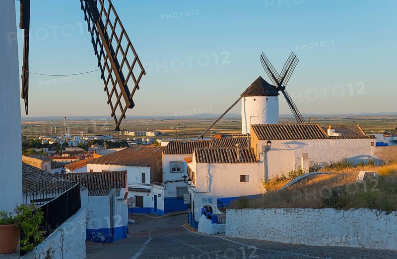 Village with white houses and a windmill at sunset, windmills and village, Campo de Criptana, province of Ciudad Real, Castilla-La Mancha, Route of Don Quixote, Spain, Europe