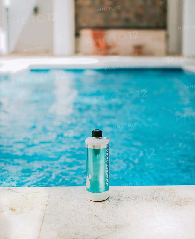 Bottle of algicide for cleaning home pools. Algicide powder for cleaning and purifying swimming pools