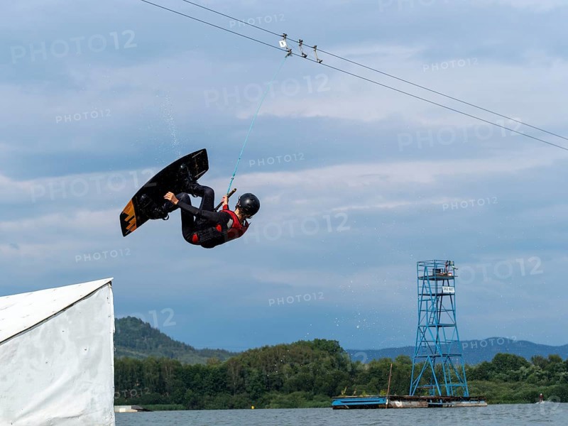 Man jumping with wakeboard over obstacle, somersault, water sports, water skiing and wakepark, Stráž pod Ralskem, Czech Republic, Europe