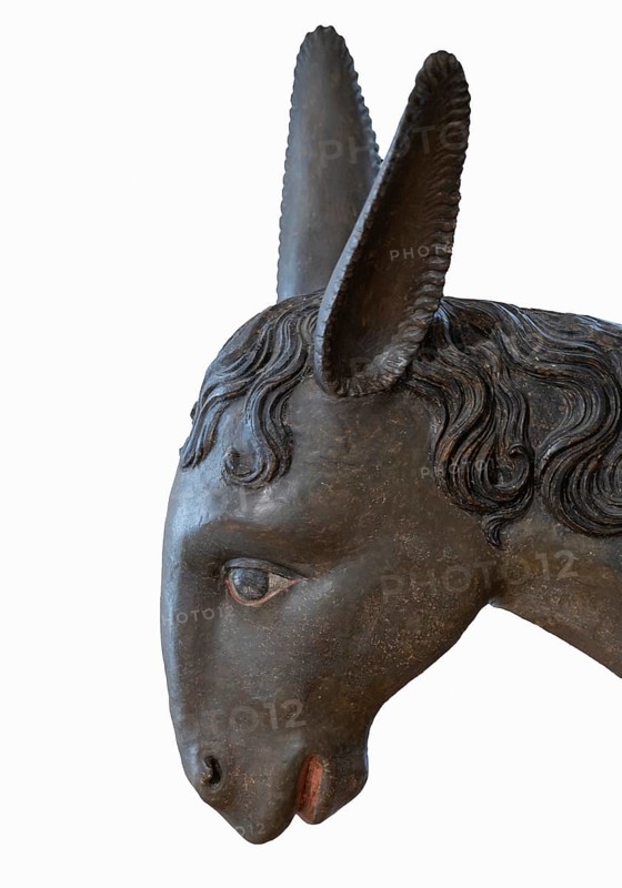 Palm donkey, detail of donkey head wooden figure from 1470, on white background, Franciscan Museum, Villingen, Baden-Württemberg, Germany, Europe