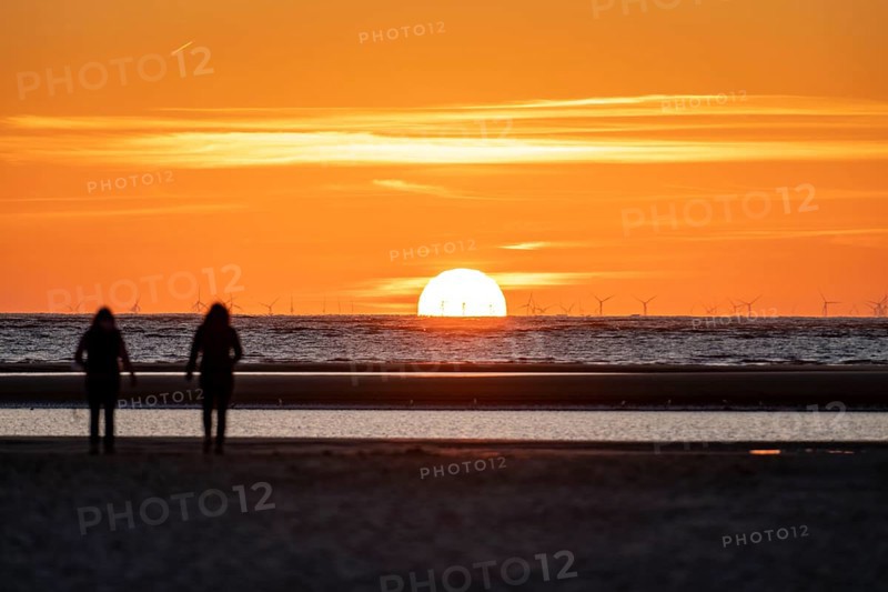 North Sea island of Langeoog, early summer, shortly after the first easing of the lockdown in the Corona crisis, still quite few tourists on the beach, offshore wind farm, sunset, Lower Saxony, Germany, Europe