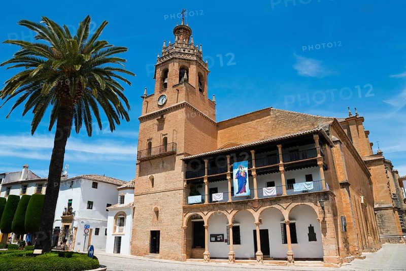 Historic church with bell tower and palm trees under a bright blue sky, Church, once a Moorish mosque, Iglesia de Santa Maria la Mayor, Old Town, Ronda, Malaga, Province of Málaga, Andalusia, Spain, Europe