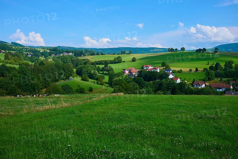 Green hills with scattered rural houses under a clear blue sky, Wachtküppel, Gersfeld, Rhön, Hesse, Germany, Europe