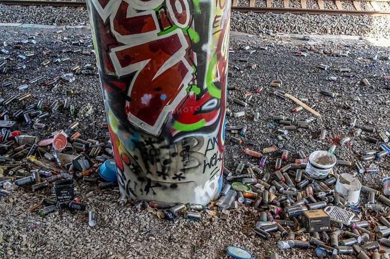 Empty spray paint cans, on a railway line below a road bridge, thrown away, disposed of by the sprayer, graffiti, rubbish heap, Essen, North Rhine-Westphalia, Germany, Europe