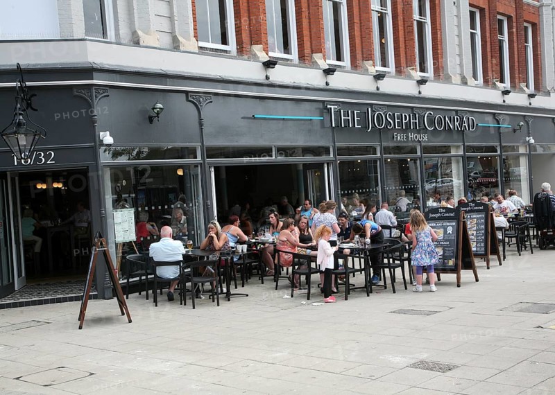 People sitting outside The Joseph Conrad Wetherspoons pub, Lowestoft, Suffolk, England, United Kingdom, Europe