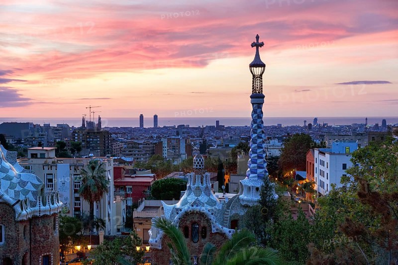 City view, building with colourful mosaics, Park Güell entrance, dawn, in front of sunrise, Barcelona, Spain, Europe