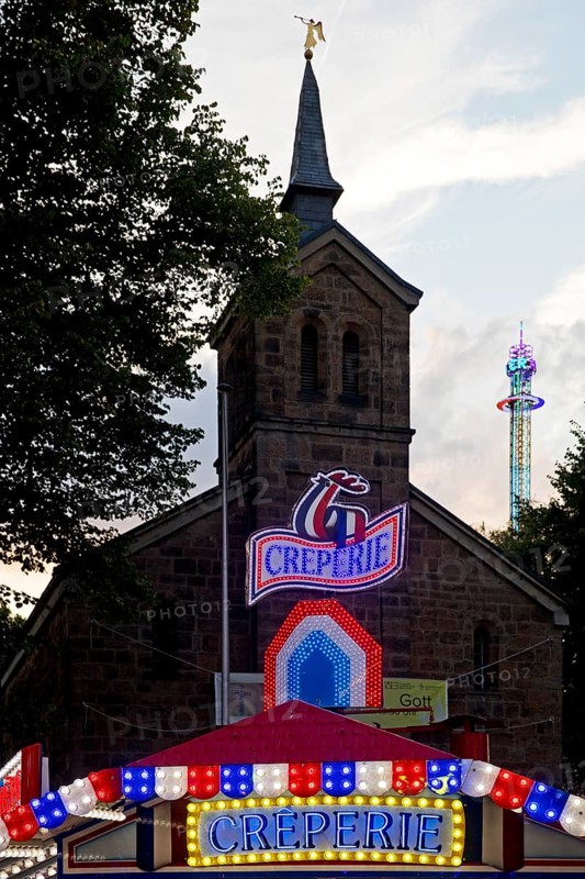 Cranger Kirche behind the Creperie and in front of the giant chain plane, Cranger Kirmes, Herne, Ruhr area, North Rhine-Westphalia, Germany, Europe