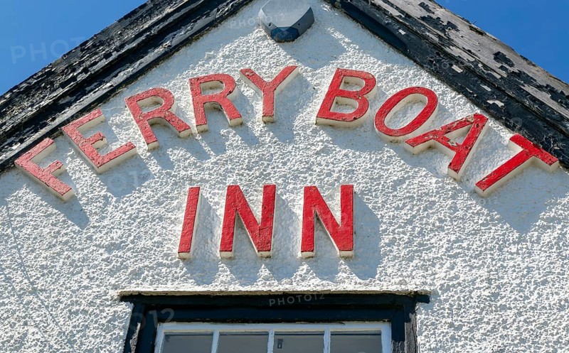 Red lettering detail of pub sign Ferry Boat Inn, Felixstowe Ferry, Suffolk, England, UK