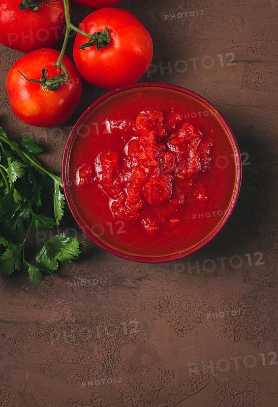 Tomatoes in their own juice, sliced, tomato sauce, tomatoes, in a cup, top view, close-up, no people