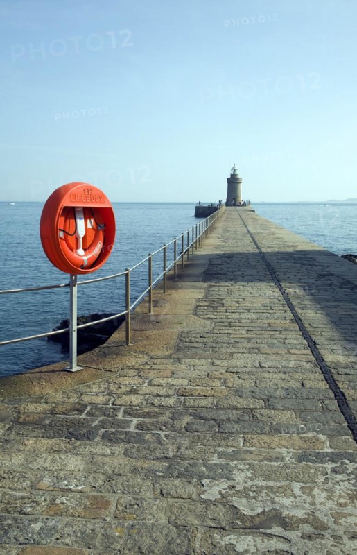 Red life saving ring on harbour breakwater, St Peter Port, Guernsey, Channel Islands, UK, Europe
