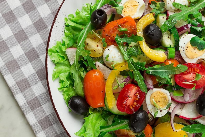 Vegetable salad, with quail eggs and olives, fresh, close-up, no people