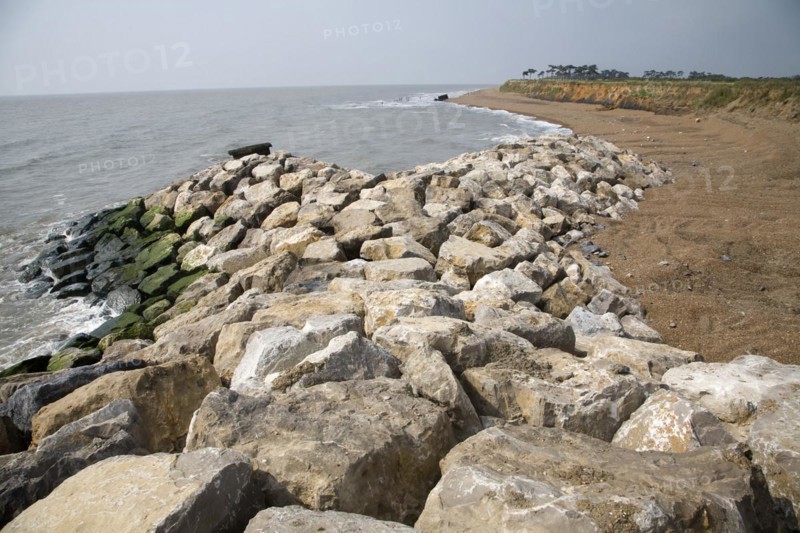 Coastal erosion and management, East Lane, Bawdsey, Suffolk, England. The new rock armour defences and massive engineering work undertaken in 2009 have been paid for through an Innovative scheme under which local farmers have donated land to be sold land for housing to pay for coastal defences. Bawdsey, Suffolk, England