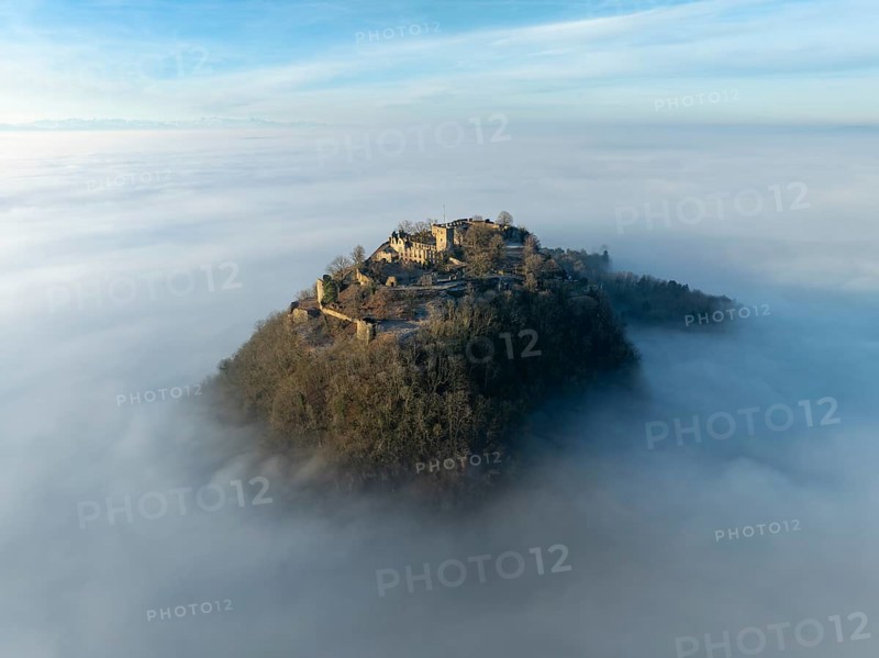 Aerial view of the Hegau volcano Hohentwiel with the upper fortress ruins illuminated by the rising sun, rising out of the fog during an inversion, district of Constance, Baden-Württemberg, Germany, Europe