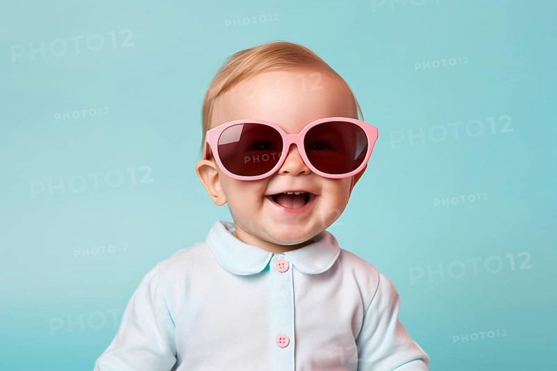 Smiling young baby or toddler with large pink sunglasses in front of pastel pink studio background. KI generiert, generiert AI generated