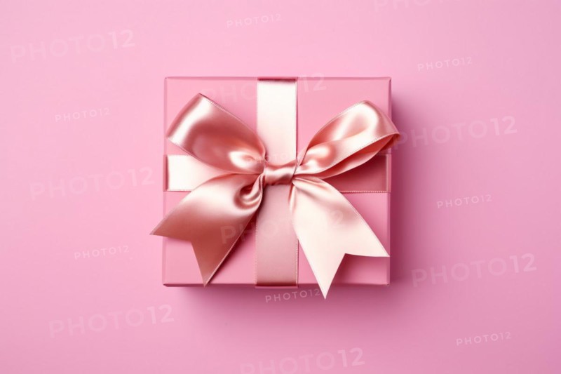Top view of pink gift box with silk bow on pink studio background. KI generiert, generiert AI generated