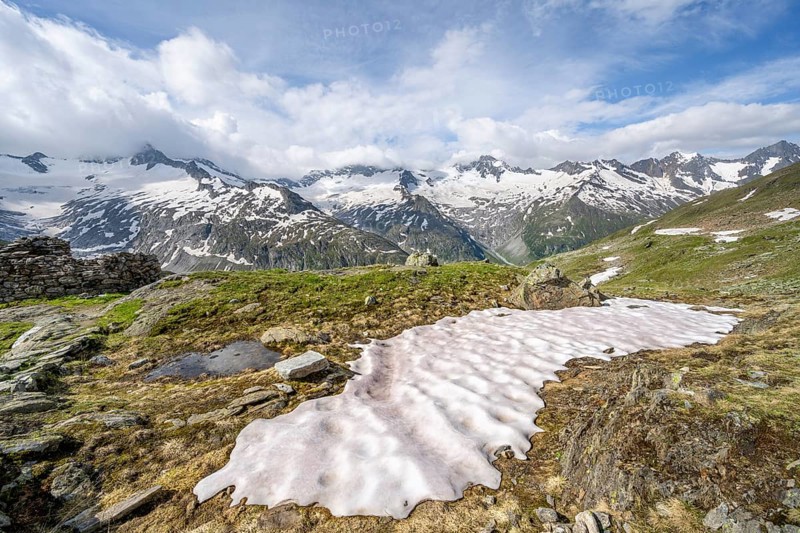 Picturesque mountain landscape with snowfield, mountain peaks with snow and glacier Schwarzensteinkees, Hornkees and Waxeggkees, Schwarzenstein summit, Hornspitzen and Großer Möseler, Berliner Höhenweg, Zillertal Alps, Tyrol, Austria, Europe