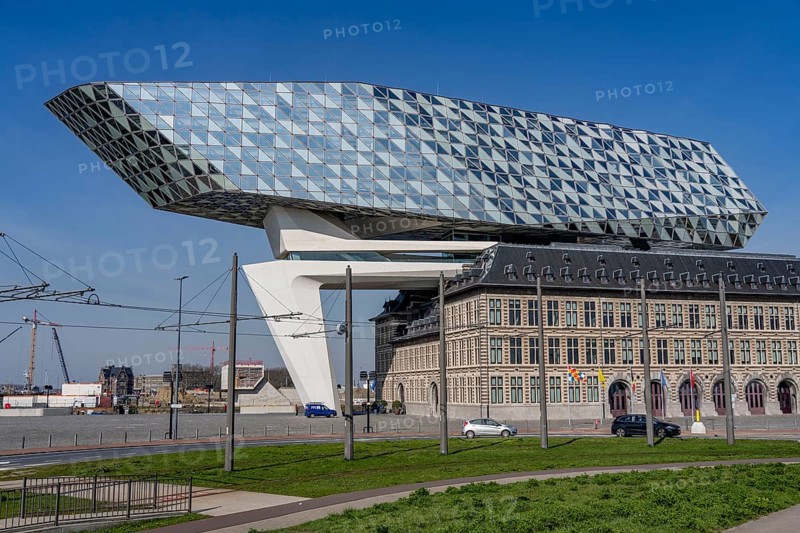 The Antwerp Port Authority building, Havenhuis, former fire brigade barracks in the harbour, renovated and with an attached glass structure in the shape of a ship's hull, administrative headquarters of the Antwerp Port Authority, designed by Zaha Hadid, Antwerp, Flanders, Belgium, Europe