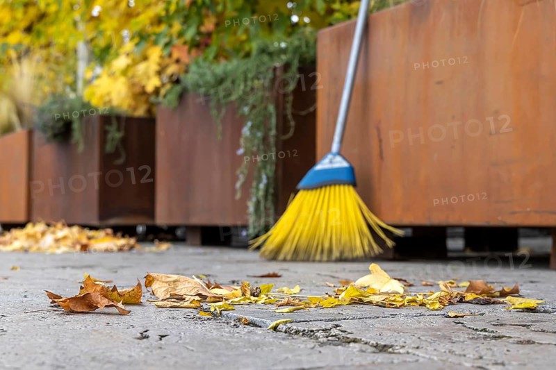 Leaves are falling from the trees. Autumn is the time for brooms to sweep the leaves off the pavement. Sweeping week in Stuttgart, Baden-Württemberg, Germany, Europe