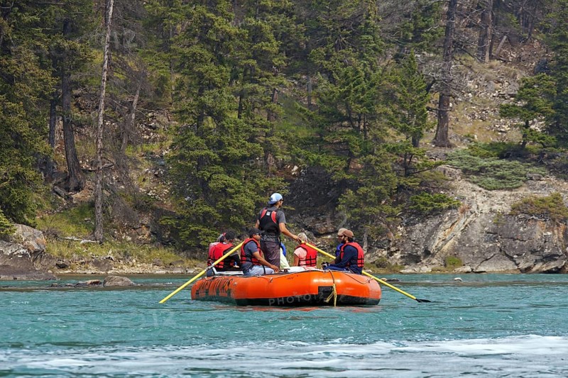 Tourists in inflatable raft rafting on the Bow River near Banff, Alberta, Canada, North America