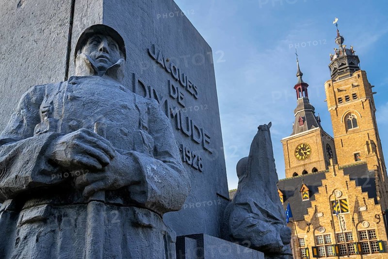 Detail of statue Jacques de Dixmude showing Belgian WWI soldier on Market square with town hall and belfy at city Diksmuide, West Flanders, Belgium, Europe