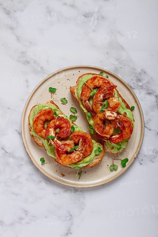 Sandwiches with avocado and caramelized shrimp, micro-greens, breakfast, on a plate, top view, homemade, no people