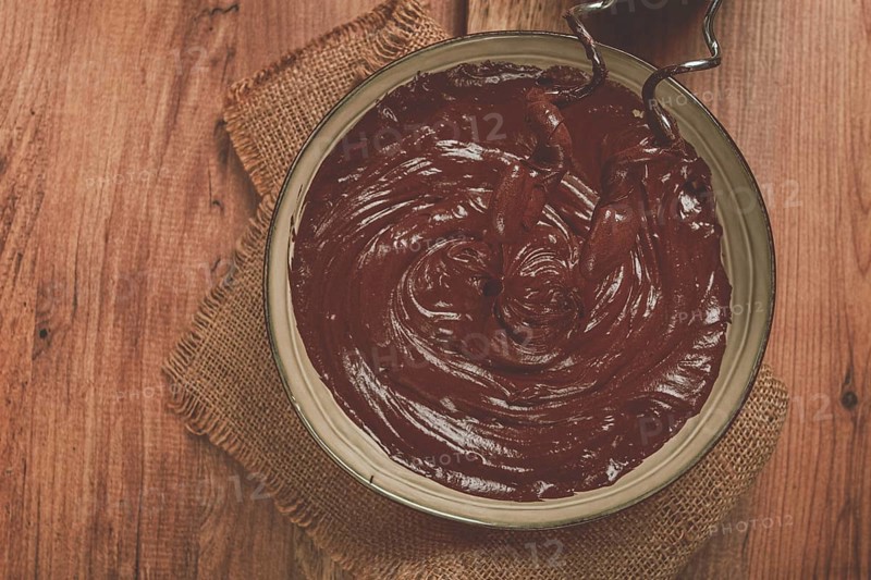 A bowl of chocolate dough, a whisk for a mixer, baking, structure and consistency, homemade, top view, no people