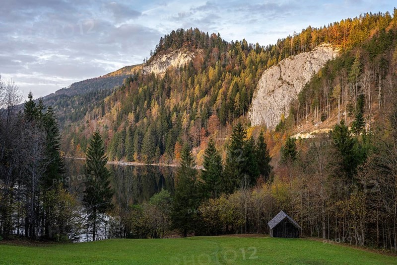 The Schwarzensee and surrounding mountains in autumn. Trees in autumn leaves. Sun and clouds. St. Wolfgang, Salzkammergut, Upper Austria, Austria, Europe