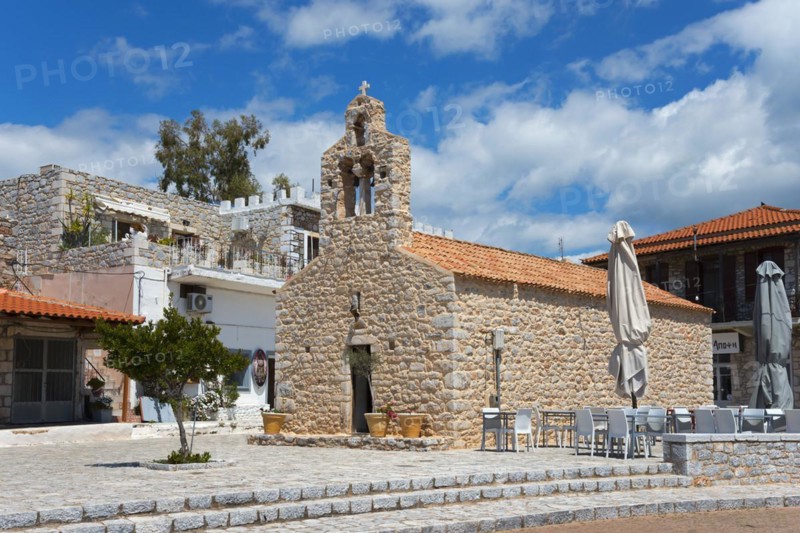 Stone church with café terrace under a partly cloudy blue sky in a relaxed setting, Church of St Athanasios, Areopoli, Areopolis, Tsimova, Itylo, Anatoliki Mani, Mani, Laconia, Peloponnese, Greece, Europe