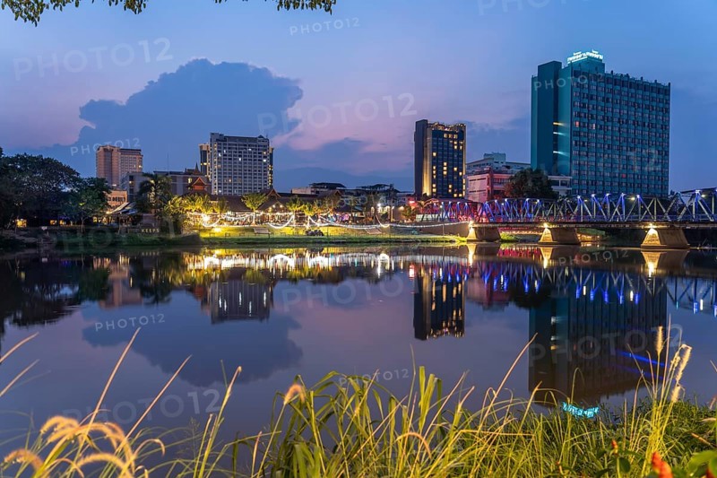 Chiang Mai skyline reflected in the Mae Nam Ping River at dusk, Chiang Mai, Thailand, Asia