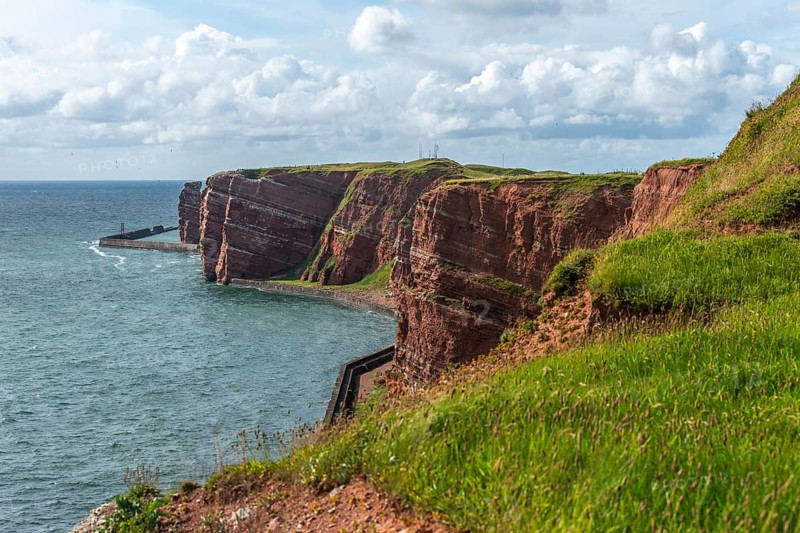 Red coloured sandstone, steep cliff coast of the offshore island of Heligoland, home of the gannets, Heligoland uplands, breakwater as wave protection, North Sea, Pinneberg district, Schleswig-Holstein, Germany, Europe