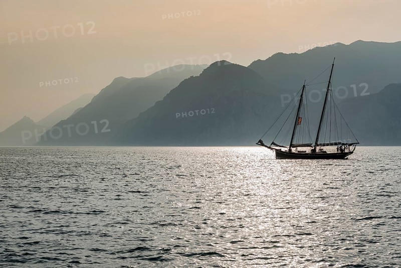 Historic sailing boat in the evening light, tourism, evening mood, sunset Lake Garda, Malcesine, Italy, Europe