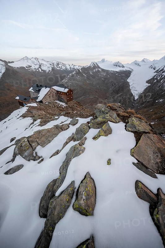 Snow-covered mountain landscape, mountain hut Ramolhaus in autumn with snow, at sunset, view of Gurgler Ferner with summit Hochwilde and Falschungsspitze, Ötztal Alps, Tyrol, Austria, Europe