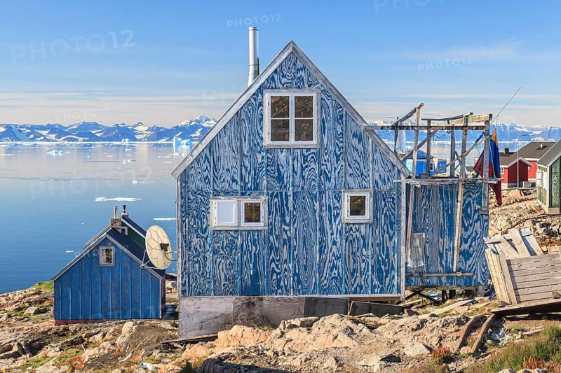 Typical Greenlandic house in an Inuit settlement on a fjord off Bergen, sunny, Ittoqqortoormiit, Scoresby Sund, East Greenland, Greenland, North America