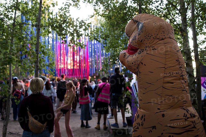 A festival visitor dressed as a dinosaur in front of a stage in the forest at the Melt Festival in Ferropolis on 13 July 2024. After a total of 27 years, the festival will take place for the last time in 2024