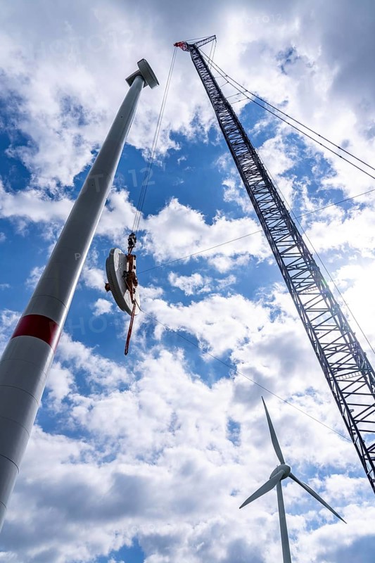 Erection of a wind turbine, wind energy plant, assembly of the ring generator, with a crawler lattice crane, wind farm near Hagen, North Rhine-Westphalia, Germany, Europe