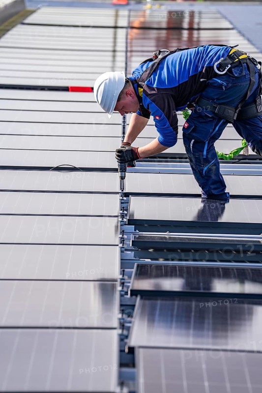 Installation of solar modules on the roof of a commercial enterprise, over 400 photovoltaic modules are installed on the roof, North Rhine-Westphalia, Germany, Europe