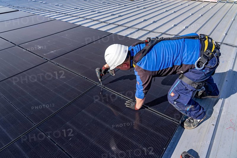 Installation of solar modules on the roof of a commercial enterprise, over 400 photovoltaic modules are installed on the roof, North Rhine-Westphalia, Germany, Europe