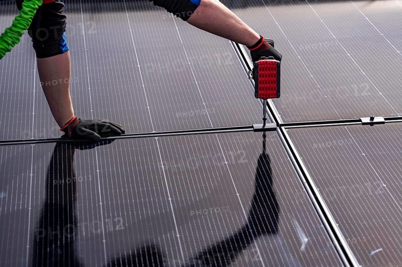 Installation of solar modules on the roof of a commercial enterprise, over 400 photovoltaic modules are installed on the roof, North Rhine-Westphalia, Germany, Europe