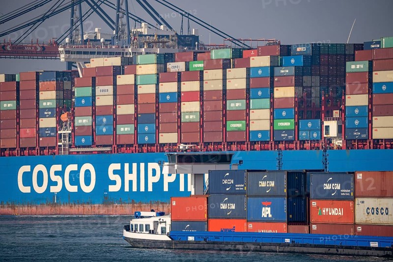 Harbour tug pushes the container freighter Cosco Shipping Leo to its berth at Hutchison Ports ECT Euromax, at the Yangtzekanaal on Maasvlakte 2, Rotterdam, Netherlands